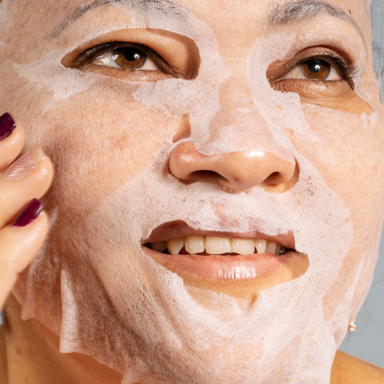 Women with anti-ageing serum treatment mask on her skin